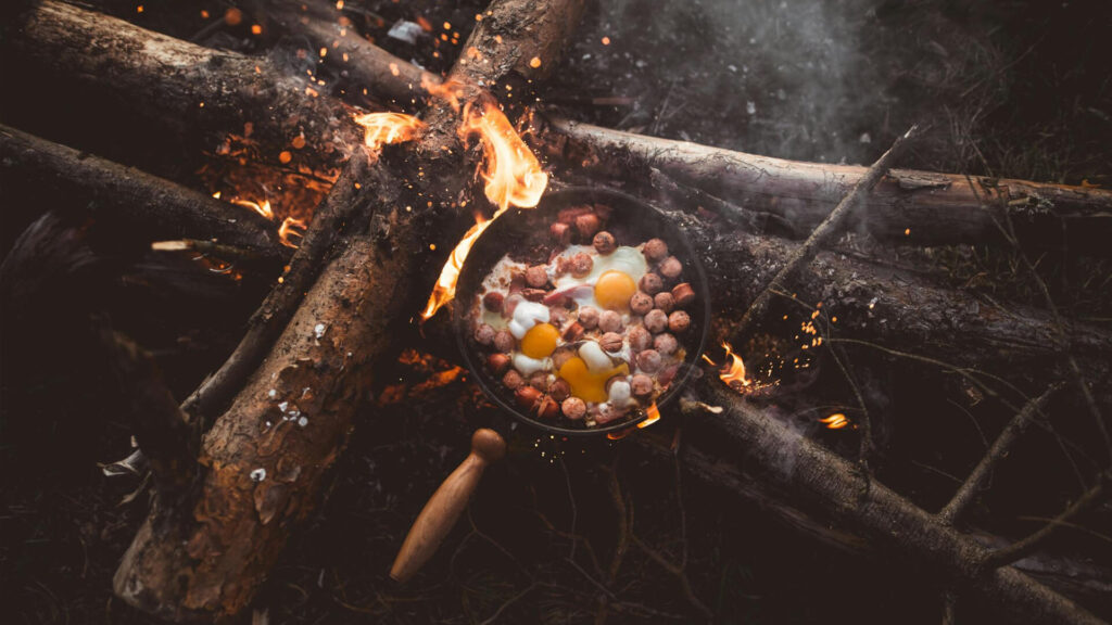  Photo of a prehistoric couple sharing food around a campfire