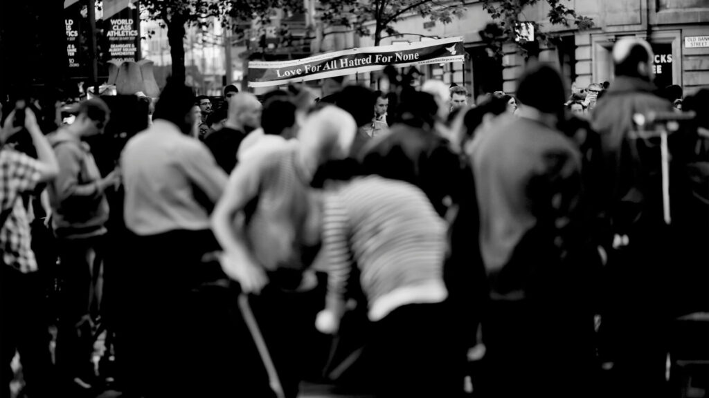 1960s protest or free love movement, vibrant crowd with peace signs.