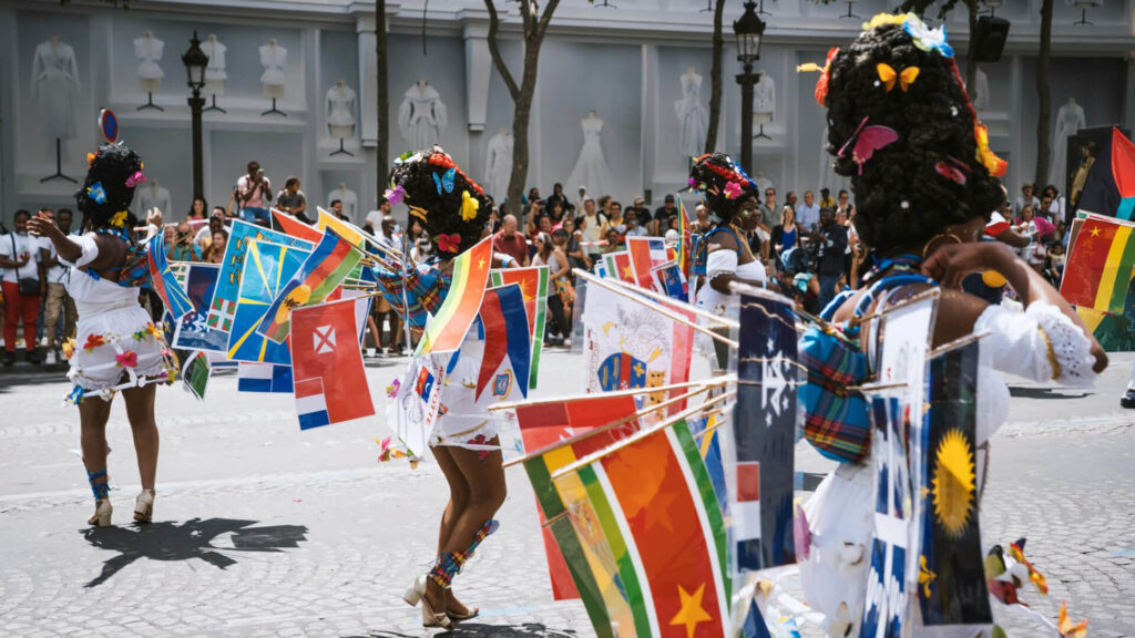 Diverse group of people celebrating pride, rainbow flags.